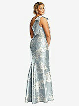 Rear View Thumbnail - Porcelain Blue Seraphina Floral Bow One-Shoulder Floral Satin Trumpet Gown